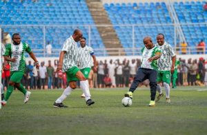 Governor Yahaya Bello with others in the field