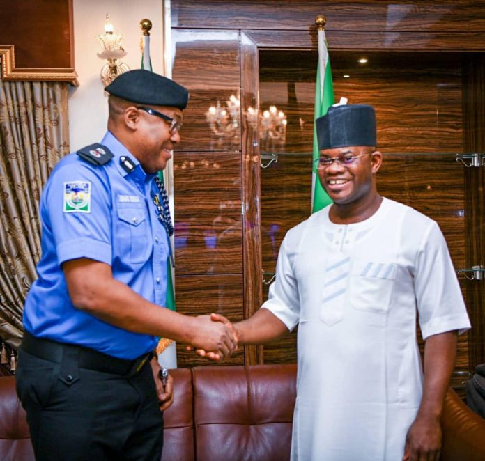 Kogi state Governor, Yahaya Bello shakes hands with the new CP, Mr Edward Egbuka at Lugard House, Lokoja