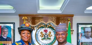Governor Yahaya Bello shakes hands with Air Commodore Musa