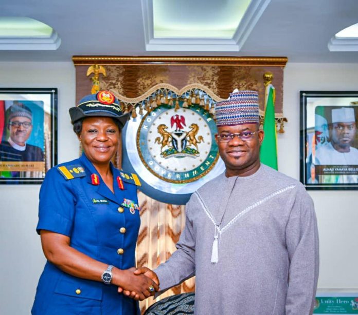 Governor Yahaya Bello shakes hands with Air Commodore Musa