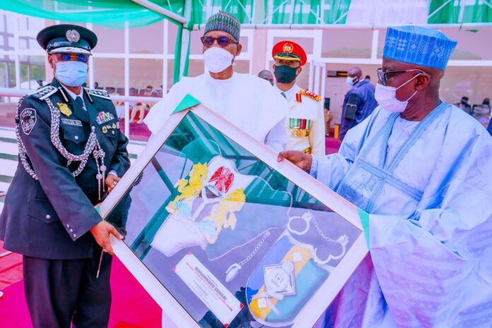 President Muhammadu Buhari receiving a presentation from Minister of Police Affairs Muhammad Digyadi and Inspector General of Police Usman Alkali Baba as he participates at the Graduation Ceremony/Passing Out Parade of Police Cadets at Police Academy Wudil, Kano State on Thursday.