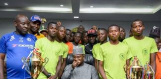 Governor Yahaya Bello in a group photograph with the U-21 and U18 handball players who returned home with medals from a Handball Tournament held in Lagos in 2019.