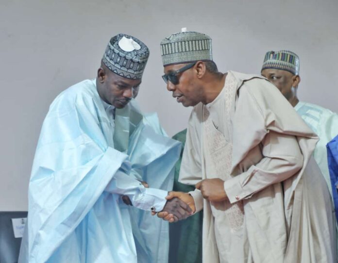 Governor Babagana Zulum (R) in a warm handshake with the Attorney General of the state, Kaka Shehu Lawan (L), at the Borno State Government House, Maiduguri, shortly after the latter was endorsed to replace Senator Kashim Shettima in the National Assembly.