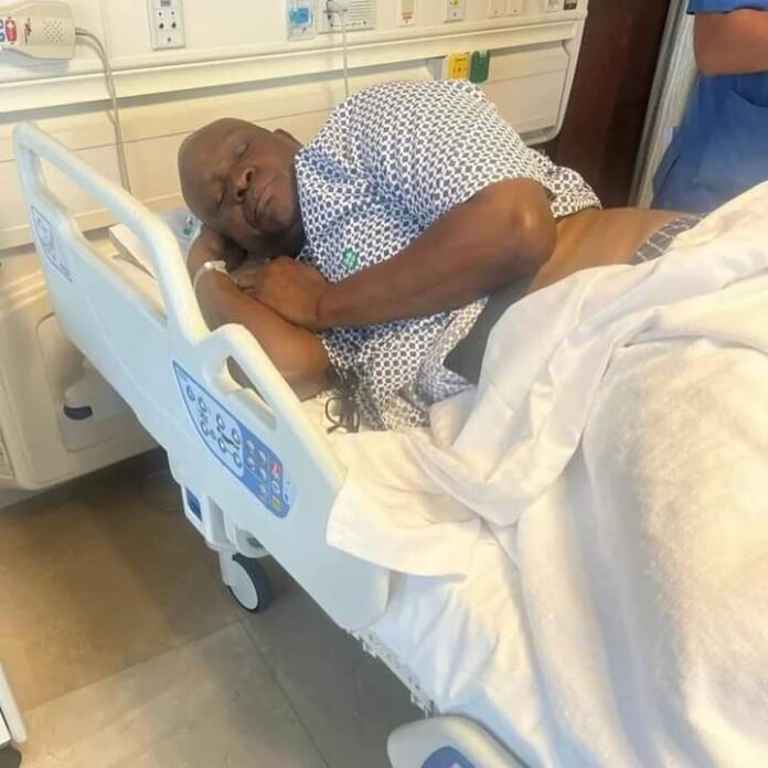 Fayose laying on the bed after the surgery