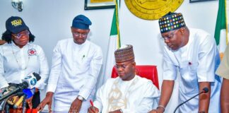 Governor Yahaya Bello signs the four bills into law