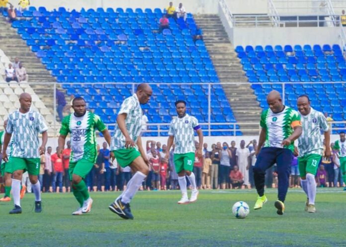 The Governor of Kogi State, Yahaya Bello in the football field trying to score a goal