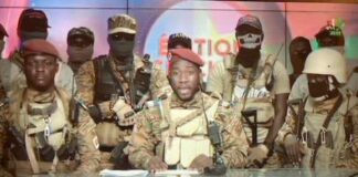 Photo caption: Captain Traore (middle) on Burkina Faso national TV announcing his takeover of power