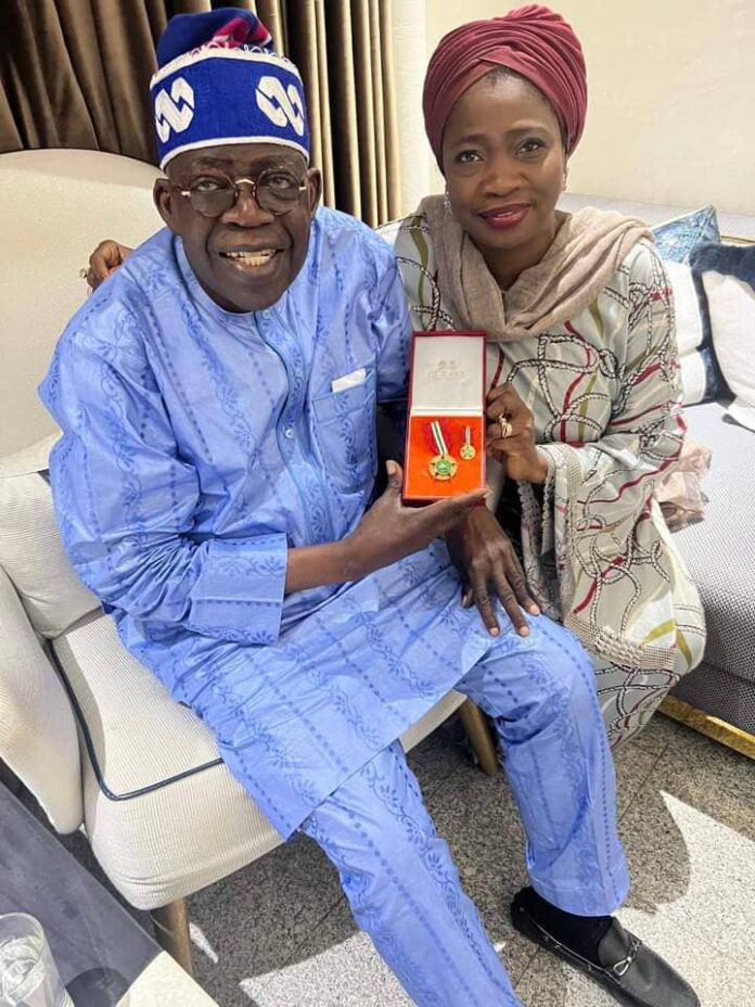 The All Progressives Congress (APC) presidential candidate, Bola Ahmed Tinubu, receiving the OON national honour given to the head of the Nigeria in Diaspora Commission (NIDCOM), Abike Dabiri-Erewa