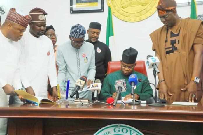 Governor Yahaya Bello signs the bill into law