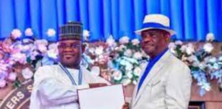 Governor Yahaya Bello (L) of Kogi state receiving the honour of Grand Service Star of Rivers State (GSSRS) from Governor Nyesom Wike (R).