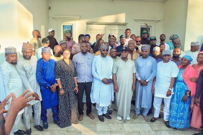 Members of APC with with Governor Yahaya Bello as he receives Haruna Ganaja