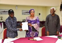 Head of the Civil Service of the Federation, Mrs Didi Esther Walson-Jack, OON,mni( middle), presenting a copy of the signed Memoranda of Understanding(MOU) on Consequential Adjustments in Salaries to the National Chairman,JNPSNC Comrade Benjamin Anthony(L), while the Chairman, National Salaries, Incomes and Wages Commission, Mr Ekpo Nta(R), looks on.