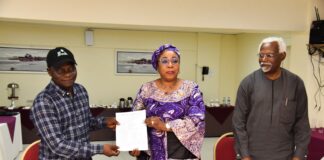 Head of the Civil Service of the Federation, Mrs Didi Esther Walson-Jack, OON,mni( middle), presenting a copy of the signed Memoranda of Understanding(MOU) on Consequential Adjustments in Salaries to the National Chairman,JNPSNC Comrade Benjamin Anthony(L), while the Chairman, National Salaries, Incomes and Wages Commission, Mr Ekpo Nta(R), looks on.