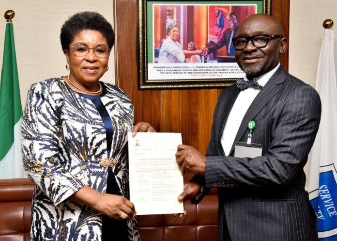 R-L: Mr Alfred Agaba Abah presenting his Letter of Appointment as SSAP to the Head of the Civil Service of the Federation, Mrs Didi Esther Walson-Jack, OON, mni.