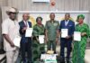 Group photograph with the Director-General of NYSC, Brigadier General Olakunle Nafiu (M)